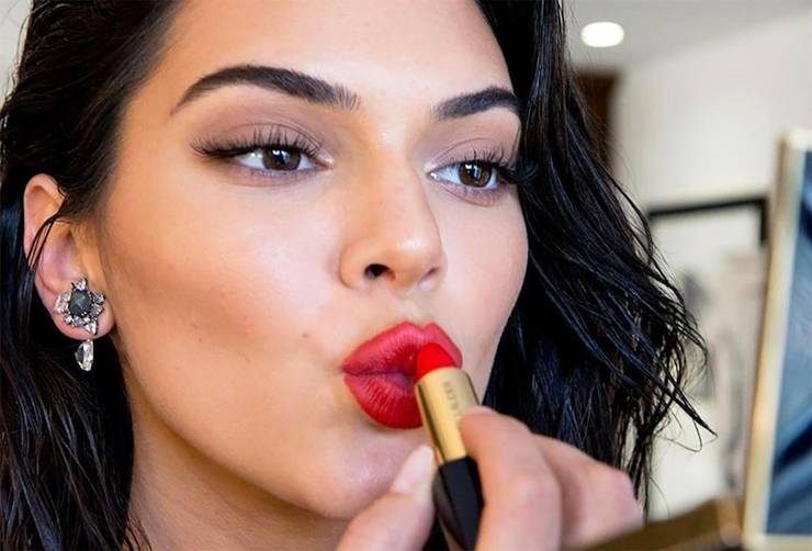 Kendall Jenner mettendo il rossetto rosso